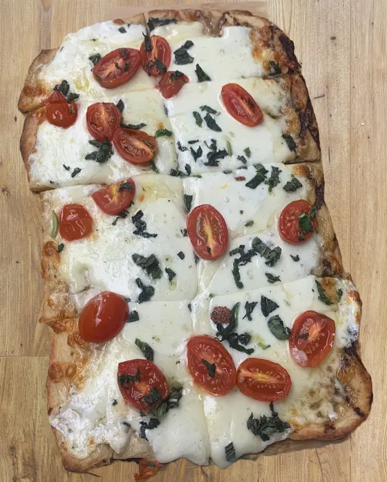 Rustic flatbread pizza with tomatoes and fresh mozzarella