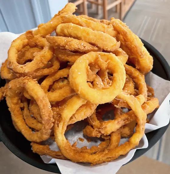 A basket of hand-cut onion rings